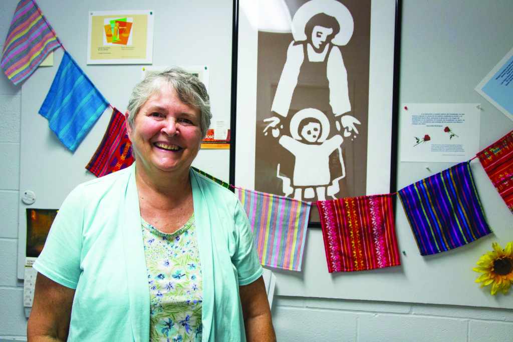 Sister Vanderneck stands in front of a picture of St. Joseph, for whom the organization is named. Photo by Claire Murray.