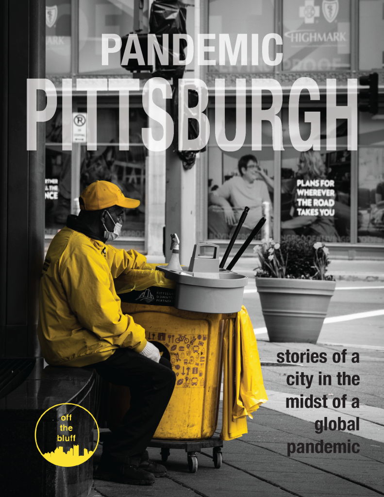 The cover of the 2022 issue of Off the Bluff, Pandemic Pittsburgh. A mostly black and white shot of a city scene in Downtown Pittsburgh. The main subject, a man sitting on the sidewalk, is wearing a yellow jacket and hat.